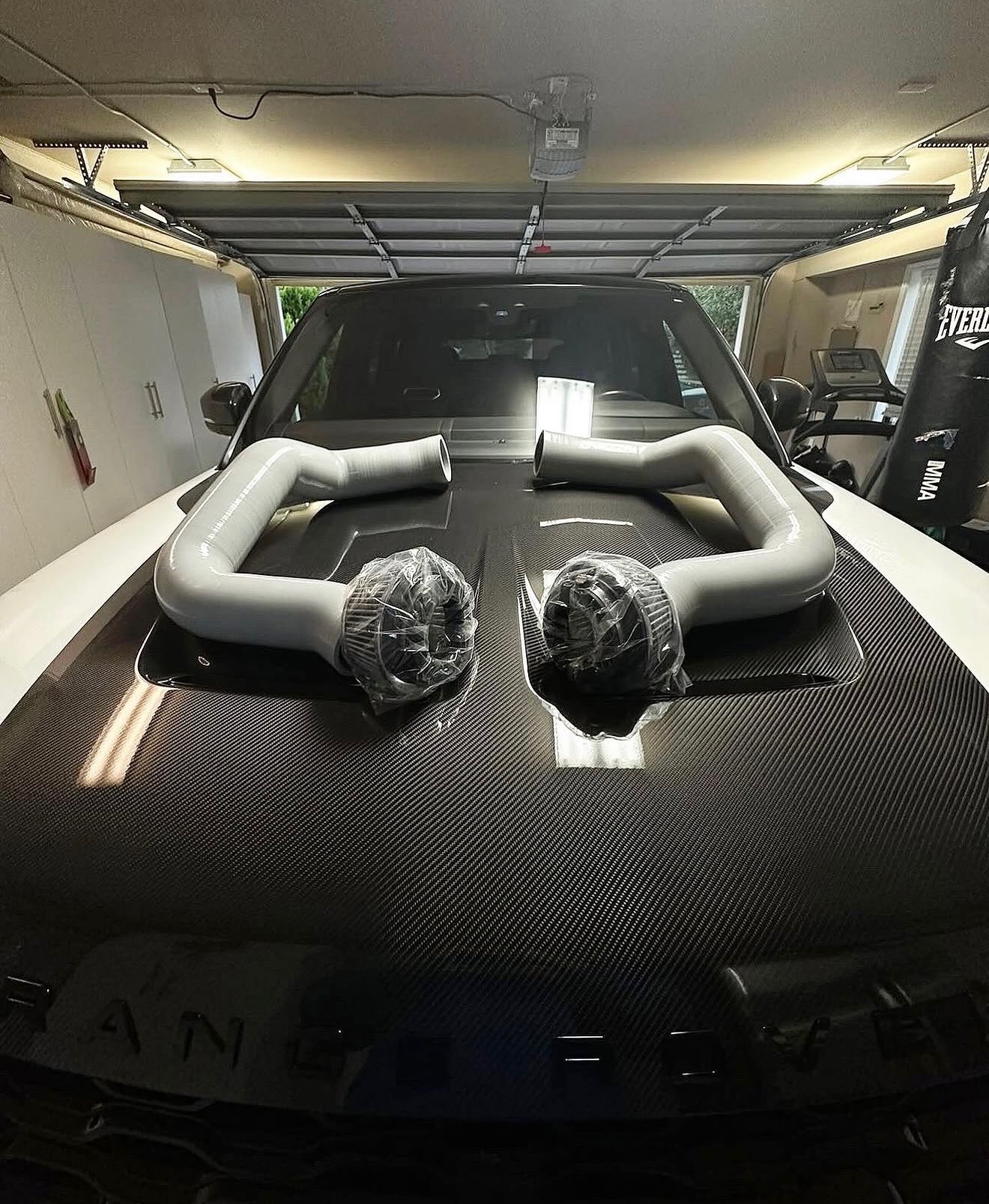 HydroArmorTech intake tubes mounted on a Range Rover carbon hood